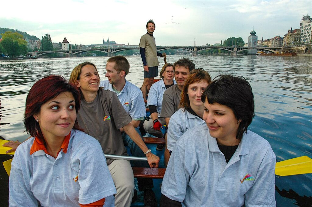 Clients on a dragon boat near the Dancing House in Prague